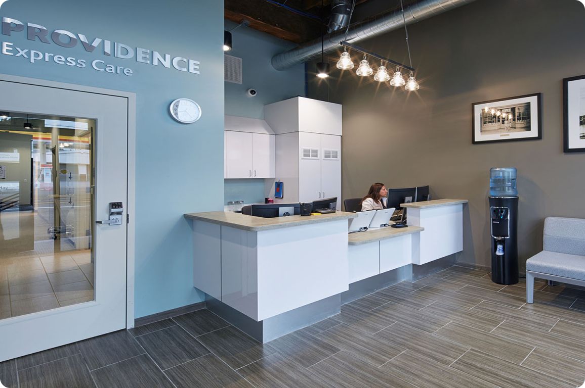 PS&D partner Providence's ExpressCare lobby with a receptionist in a modern and clean lobby.